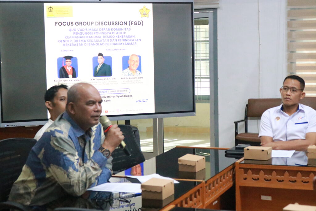 A person speaking into a microphone

Description automatically generated